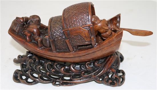 A Chinese bamboo model of a junk boat, with a stand carved as waves, late 19th/early 20th century, length 30cm